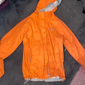 North face windbreaker size XS the color is a orange pink in picture it’s dif